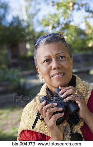 African woman holding binoculars View Large Photo Image Stock Image - African woman holding binoculars. Fotosearch