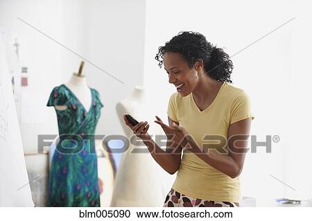 African woman laughing at text message View Large Photo Image Stock Image - African woman laughing at text message. Fotosearch