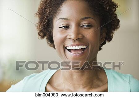 African woman laughing in living room View Large Photo Image Stock Image - African woman laughing in living room. Fotosearch