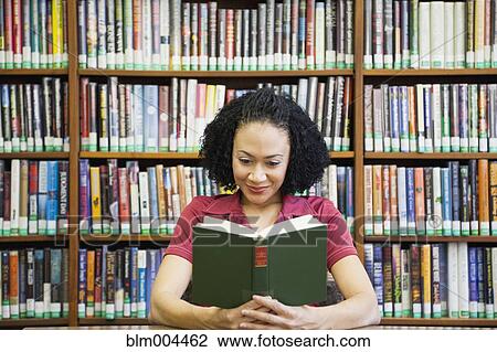 African woman reading book in library View Large Photo Image Stock Image - African woman reading book in library. Fotosearch