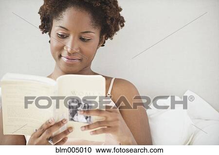 African woman reading in bed View Large Photo Image Stock Image - African woman reading in bed. Fotosearch