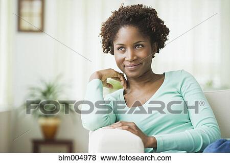 African woman relaxing in living room View Large Photo Image Stock Photo - African woman relaxing in living room. Fotosearch