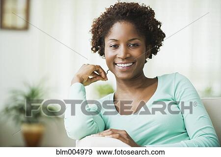 African woman relaxing in living room View Large Photo Image Stock Photo - African woman relaxing in living room. Fotosearch