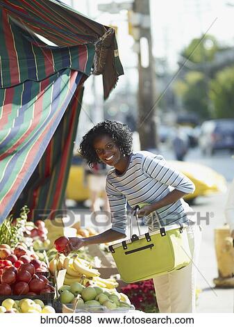 African woman shopping at vegetable market View Large Photo Image Stock Photo - African woman shopping at vegetable market. Fotosearch