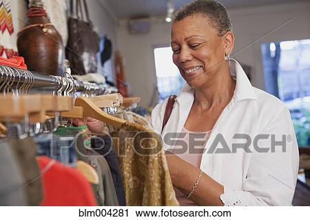 African woman shopping in clothing store View Large Photo Image Stock Image - African woman shopping in clothing store. Fotosearch