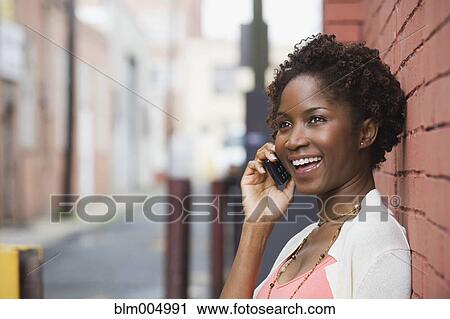 African woman talking on cell phone View Large Photo Image Stock Image - African woman talking on cell phone. Fotosearch