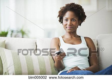 African woman watching television View Large Photo Image Stock Image - African woman watching television. Fotosearch
