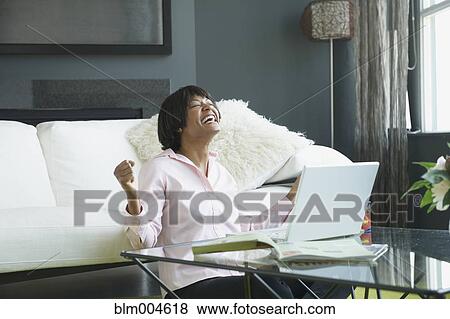 African woman with laptop laughing View Large Photo Image Stock Photo - African woman with laptop laughing. Fotosearch
