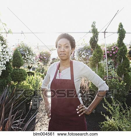 African woman working in garden nursery View Large Photo Image Stock Image - African woman working in garden nursery. Fotosearch