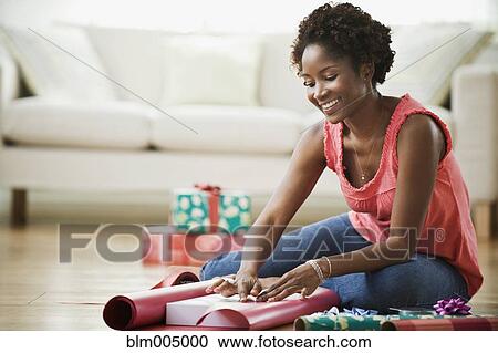 African woman wrapping presents View Large Photo Image Stock Image - African woman wrapping presents. Fotosearch