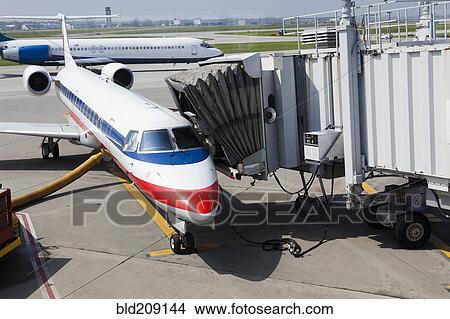 Picture - Airplane and boarding apparatus on runway. Fotosearch