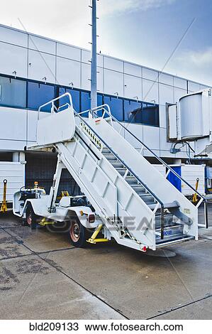 Stock Image - Airplane staircase on runway. Fotosearch
