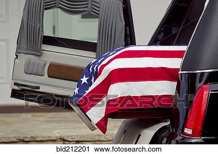 Stock Image - American flag over casket at military funeral. Fotosearch