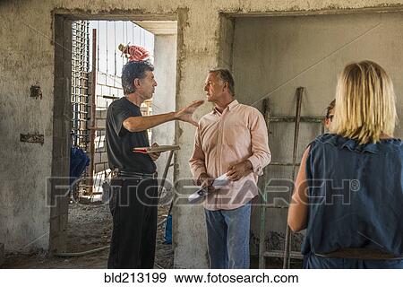 Stock Photo - Architects talking at construction site. Fotosearch
