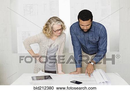 Stock Image - Architects working together in office. Fotosearch
