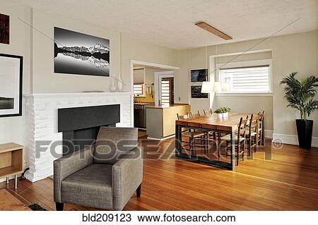 Stock Image - Armchair and dining table in modern craftsman home. Fotosearch