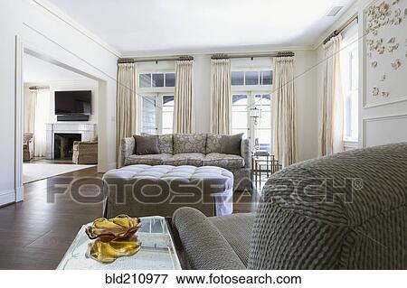 Stock Photo - Armchair and sofa in ornate living room. Fotosearch