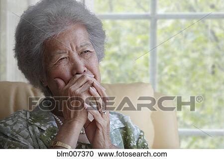 Asian woman covering mouth with hand View Large Photo Image Stock Image - Asian woman covering mouth with hand. Fotosearch