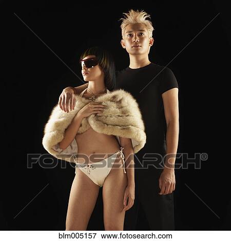 Asian woman in bikini and fur wrap with boyfriend View Large Photo Image Stock Photo - Asian woman in bikini and fur wrap with boyfriend. Fotosearch