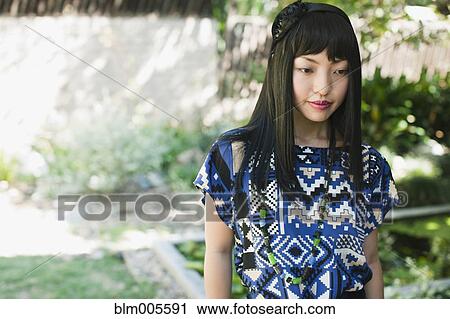 Asian woman in glamorous dress and hat View Large Photo Image Stock Image - Asian woman in glamorous dress and hat. Fotosearch