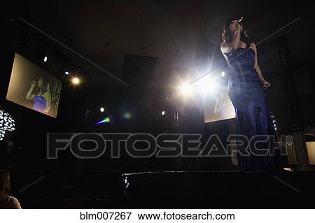 Asian woman performing karaoke View Large Photo Image Stock Photo - Asian woman performing karaoke. Fotosearch