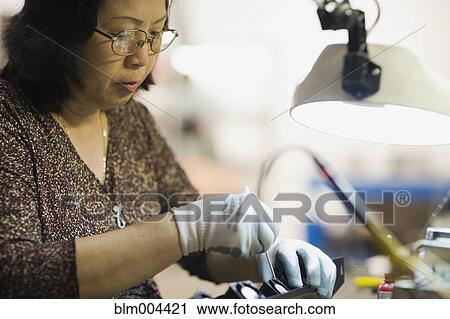 Asian woman repairing technology equipment View Large Photo Image Stock Image - Asian woman repairing technology equipment. Fotosearch