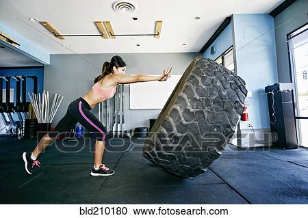Asian woman working out in gym View Large Photo Image Stock Image - Asian woman working out in gym. Fotosearch