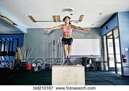 Asian woman working out in gym View Large Photo Image Stock Photo - Asian woman working out in gym. Fotosearch
