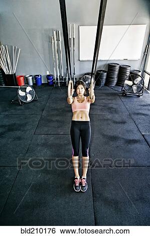 Stock Photograph - Asian woman working out in gym. Fotosearch
