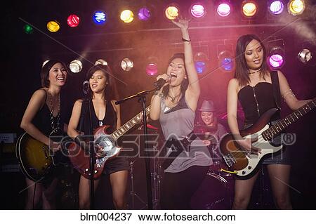 Asian women singing and playing guitar onstage View Large Photo Image Stock Photo - Asian women singing and playing guitar onstage. Fotosearch