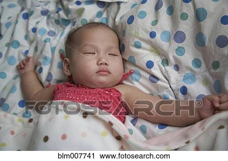 Baby girl sleeping in bed View Large Photo Image Stock Image - Baby girl sleeping in bed. Fotosearch