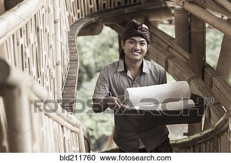 Balinese man carrying rolled towels in hotel, Ubud, Bali, Indonesia View Large Photo Image Stock Image - Balinese man carrying rolled towels in hotel, Ubud, Bali, Indonesia. Fotosearch