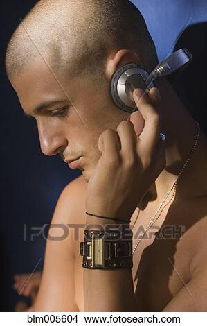 Bare chested Native American man listening to headphones View Large Photo Image Picture - Bare chested Native American man listening to headphones. Fotosearch