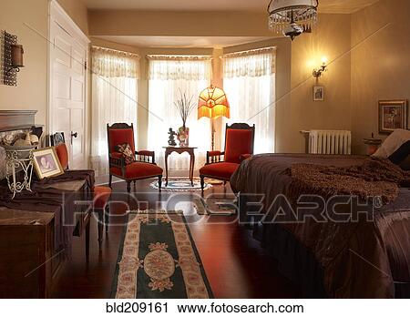 Stock Image - Bedroom in Victorian house. Fotosearch