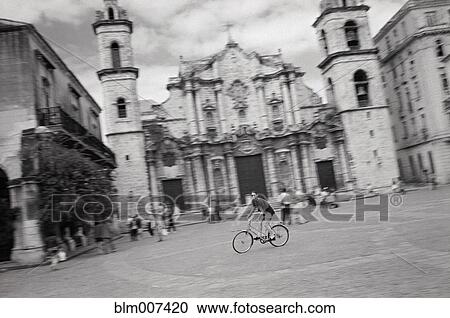 Bicyclist crossing town square View Large Photo Image Stock Image - Bicyclist crossing town square. Fotosearch