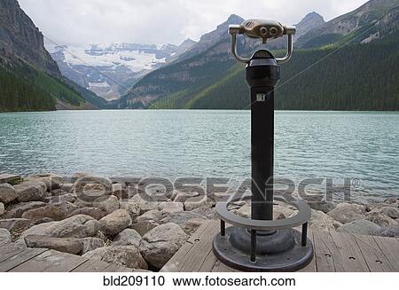 Stock Image - Binoculars overlooking Lake Louise, Alberta, Canada. Fotosearch