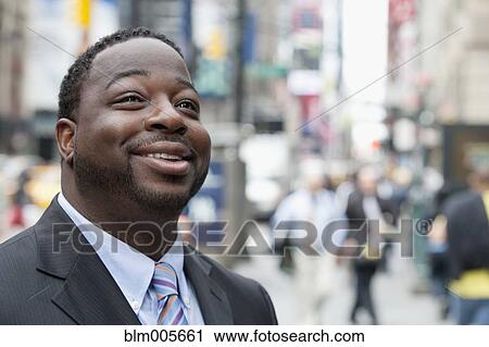 Black businessman smiling on urban street View Large Photo Image Stock Image - Black businessman smiling on urban street. Fotosearch