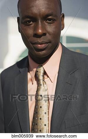Stock Photo - Black businessman smiling. Fotosearch