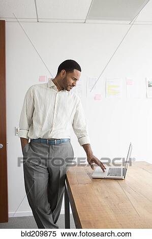 Black businessman working in office View Large Photo Image Stock Photography - Black businessman working in office. Fotosearch