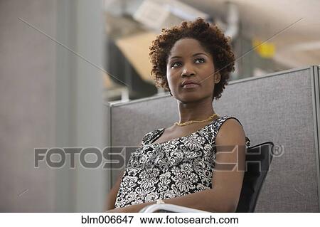 Black businesswoman sitting in office cubicle View Large Photo Image Stock Photo - Black businesswoman sitting in office cubicle. Fotosearch