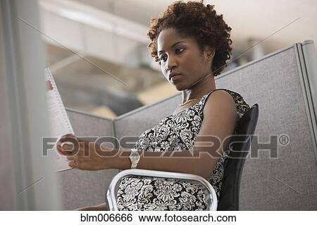 Black businesswoman working in office cubicle View Large Photo Image Stock Photograph - Black businesswoman working in office cubicle. Fotosearch