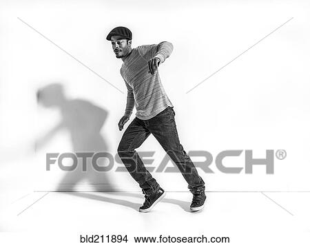 Picture - Black dancer casting shadow on wall. Fotosearch