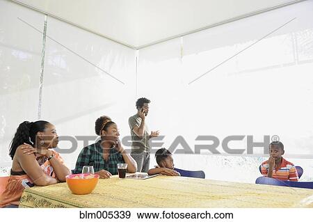 Stock Photo - Black family eating at dining room table. Fotosearch