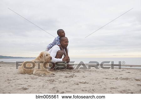 Black father and son hugging on beach View Large Photo Image Stock Image - Black father and son hugging on beach. Fotosearch