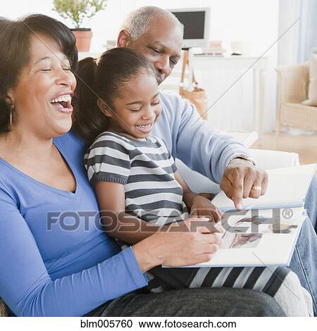 Black grandparents looking at photographs with granddaughter View Large Photo Image Stock Image - Black grandparents looking at photographs with granddaughter. Fotosearch