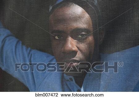 Stock Image - Black man behind screen. Fotosearch