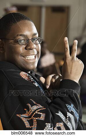 Stock Photo - Black man making peace sign gesture. Fotosearch