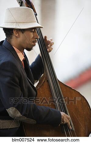Picture - Black man playing bass. Fotosearch