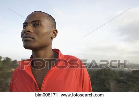 Black man standing outdoors View Large Photo Image Stock Image - Black man standing outdoors. Fotosearch