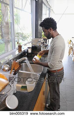 Black man washing dishes View Large Photo Image Stock Photo - Black man washing dishes. Fotosearch